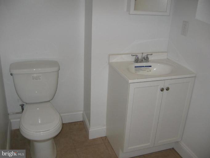 2209 Monticello Road Baltimore, MD 21216 - Photo 20 of 30 a bathroom with a toilet sink and mirror
