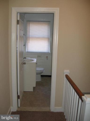 2209 Monticello Road Baltimore, MD 21216 - Photo 26 of 30 a view of a bathroom with a toilet sink and a mirror