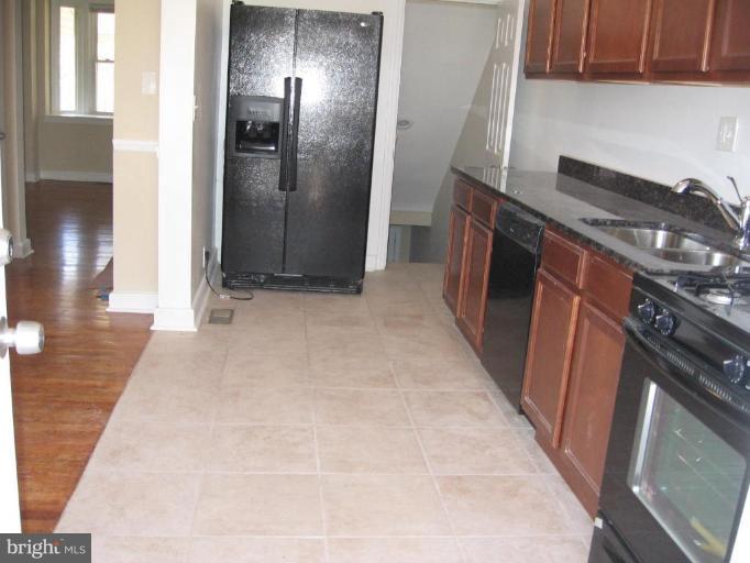 2209 Monticello Road Baltimore, MD 21216 - Photo 10 of 30 a kitchen with stainless steel appliances granite countertop a refrigerator and a stove