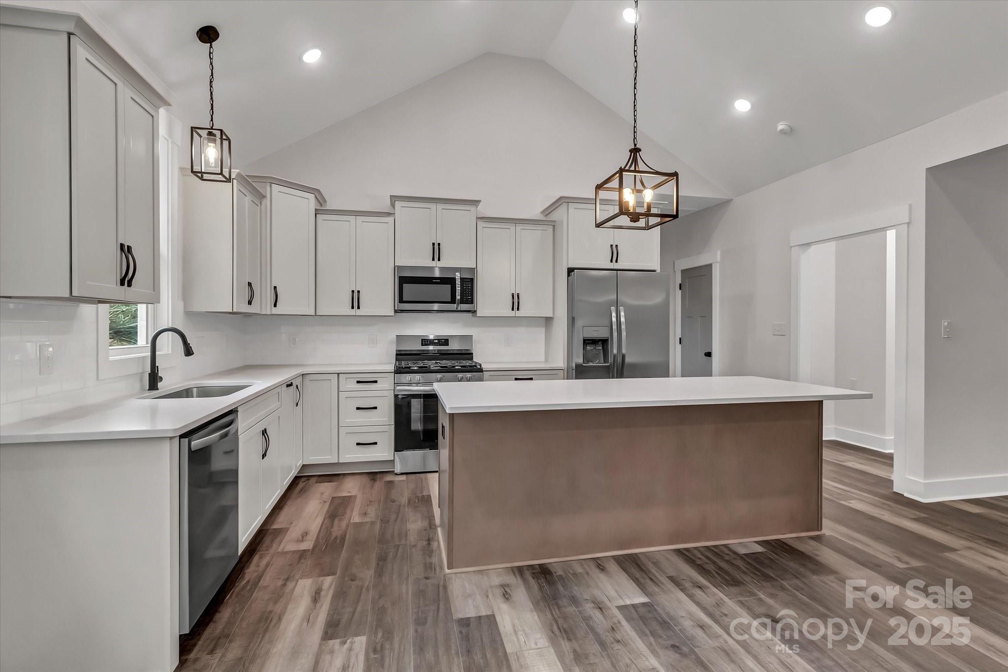 2147 Dunlap Roddey Road Rock Hill, SC 29730 - Photo 11 of 27 a kitchen with kitchen island granite countertop a sink cabinets and wooden floor
