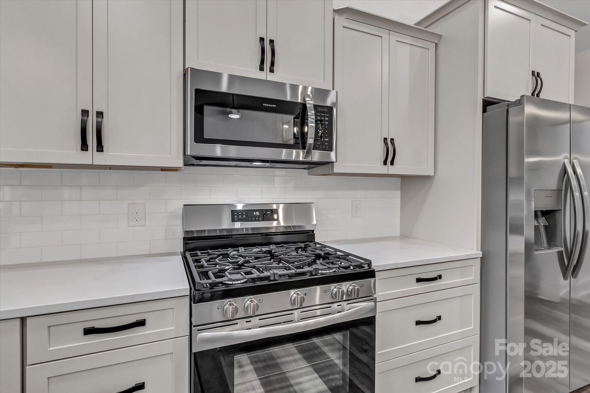 2147 Dunlap Roddey Road Rock Hill, SC 29730 - Photo 13 of 27 a kitchen with stainless steel appliances white cabinets and a stove top oven