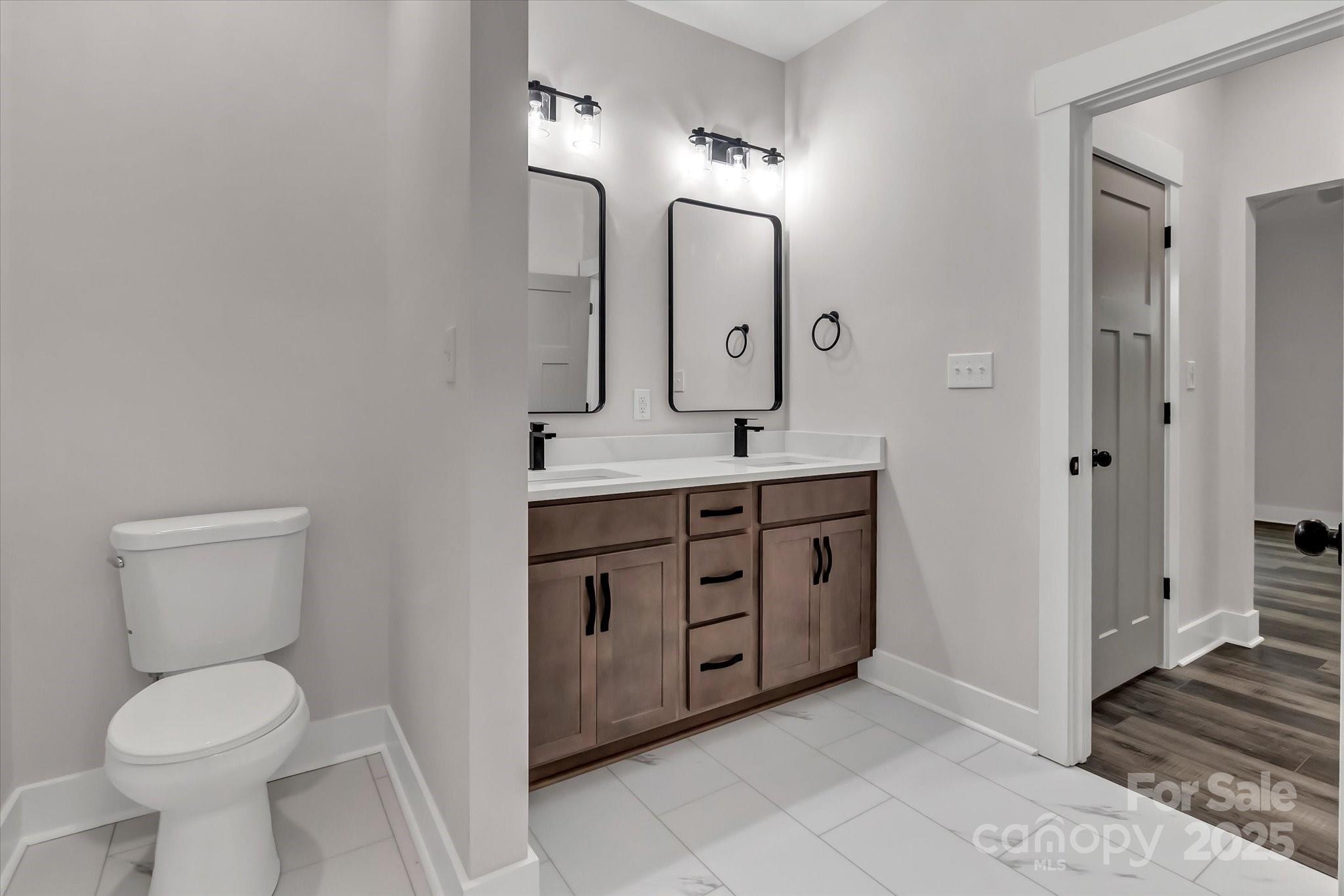 2147 Dunlap Roddey Road Rock Hill, SC 29730 - Photo 18 of 27 a spacious bathroom with a toilet sink and mirror