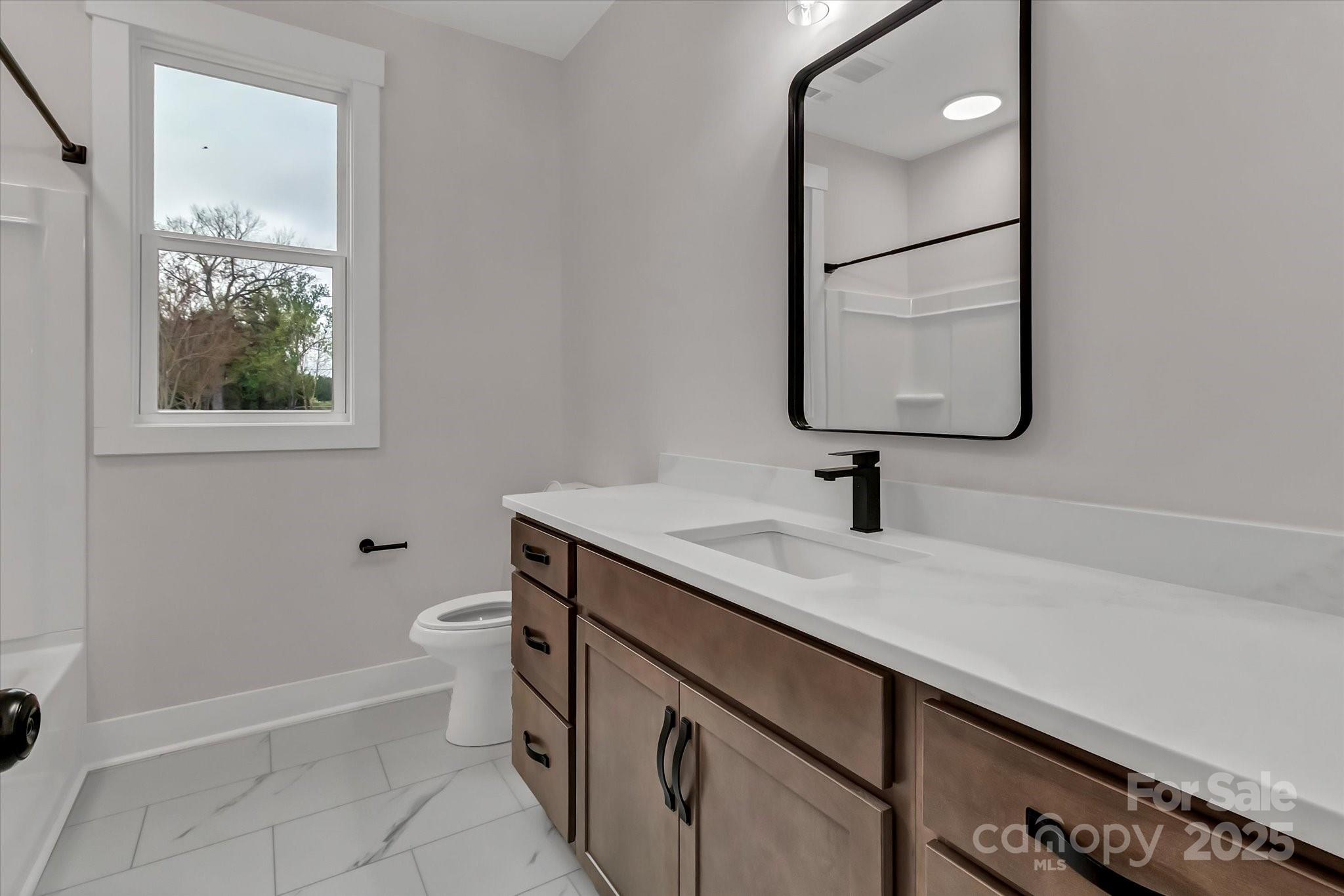 2147 Dunlap Roddey Road Rock Hill, SC 29730 - Photo 21 of 27 a bathroom with a granite countertop sink a toilet and a mirror
