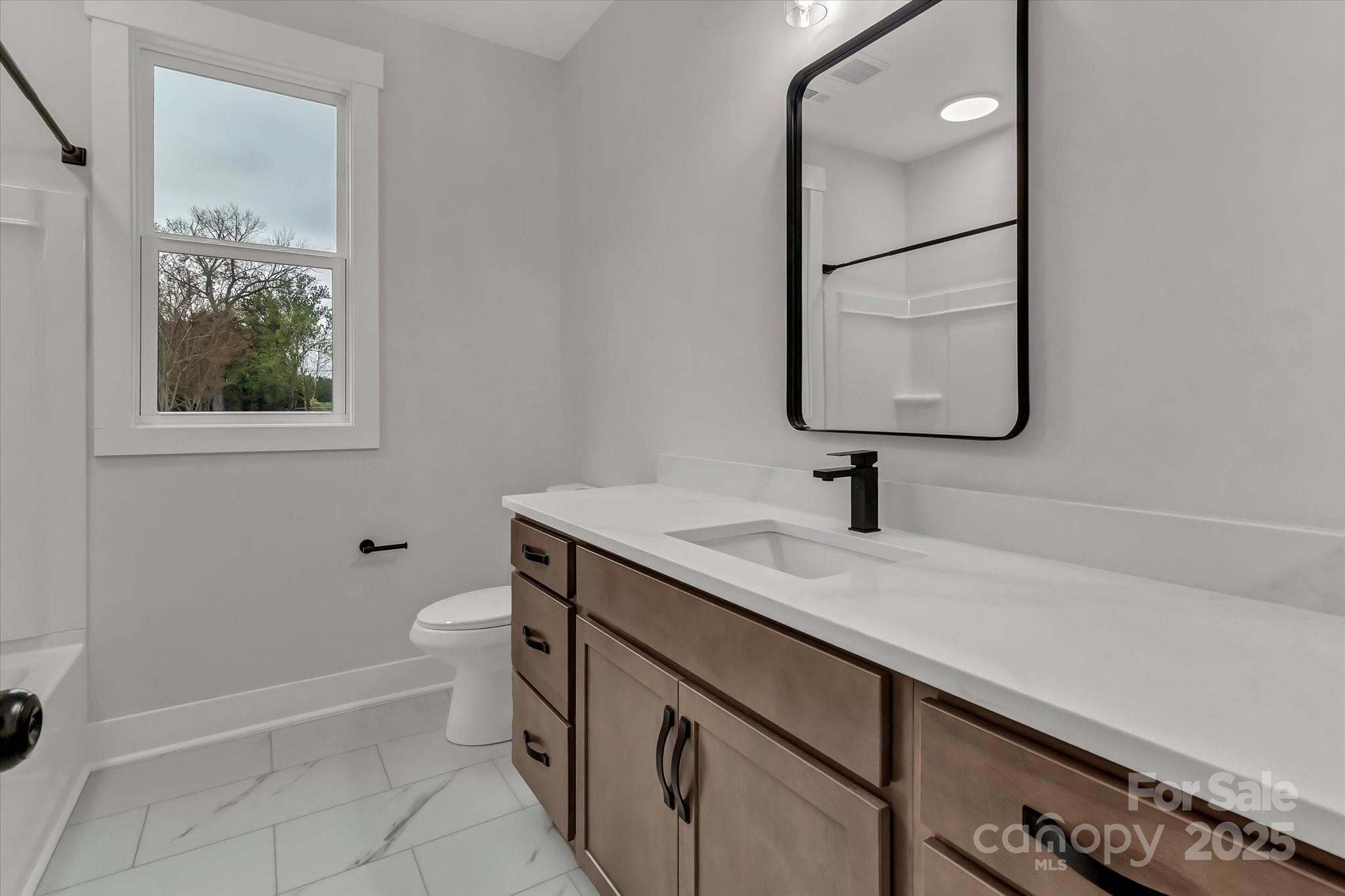 2147 Dunlap Roddey Road Rock Hill, SC 29730 - Photo 22 of 27 a bathroom with a sink a toilet and a mirror