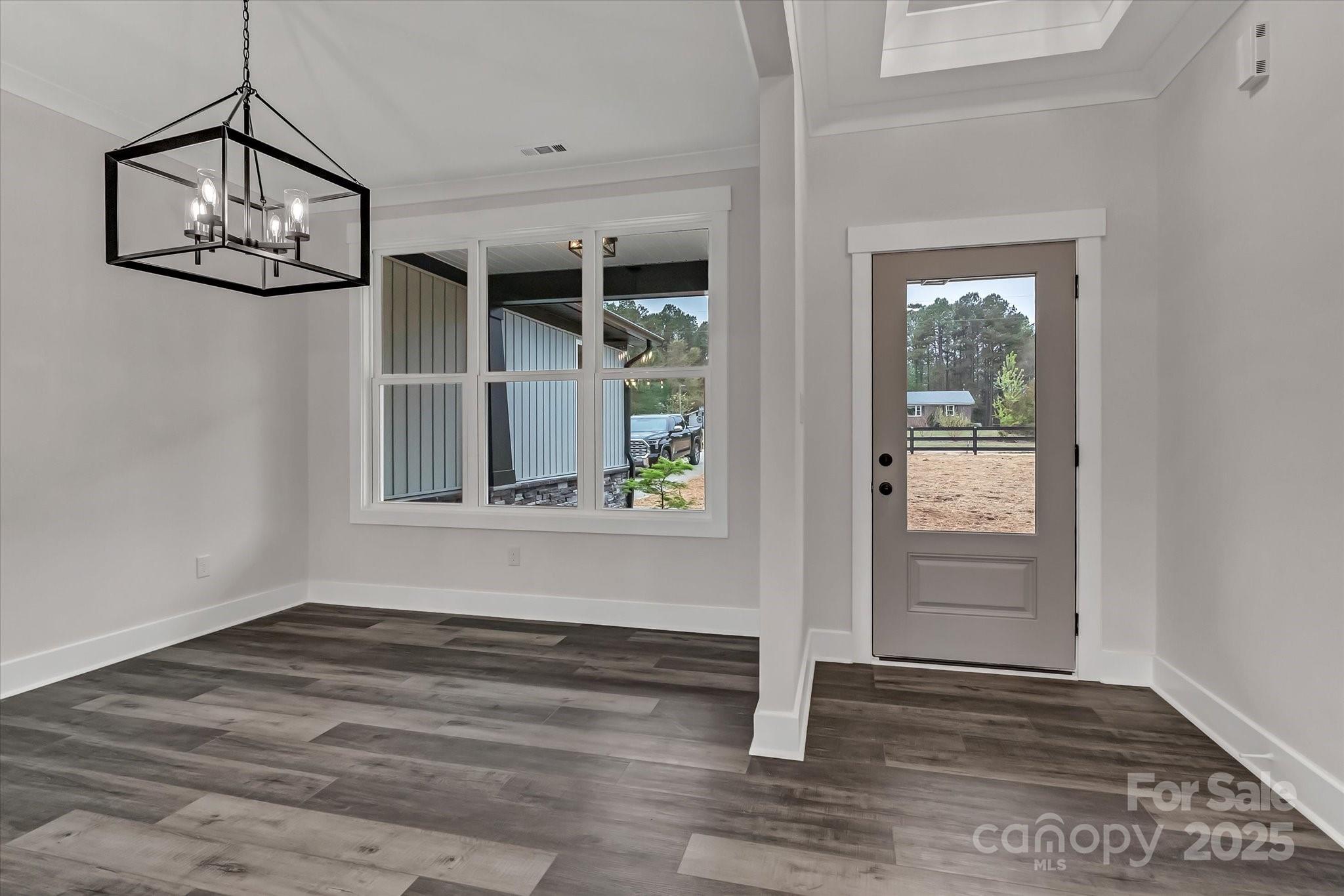 2147 Dunlap Roddey Road Rock Hill, SC 29730 - Photo 8 of 27 an empty room with wooden floor a ceiling fan and windows