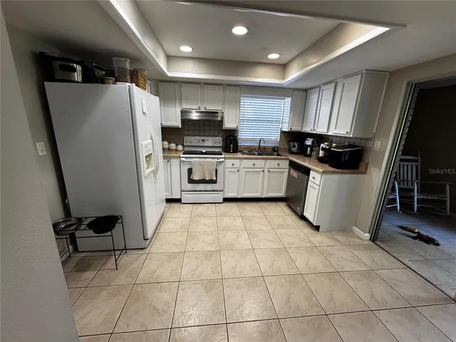 a kitchen with stainless steel appliances a refrigerator sink and microwave
