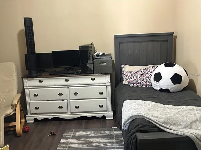 a bedroom with a bed and flat screen tv