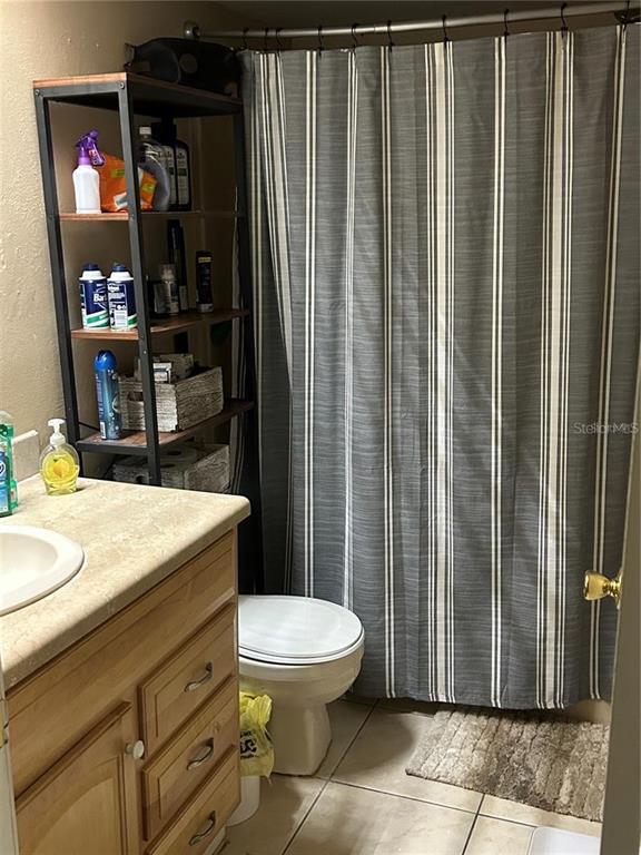 423 Greenfield Road Winter Haven, FL 33884 - Photo 10 of 14 a bathroom with a granite countertop sink toilet and shower