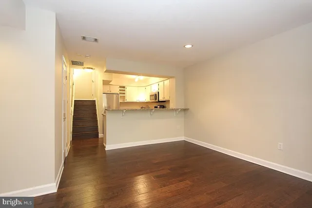 a view of a kitchen with a sink and cabinets