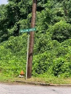 a sign broad in the middle of a forest