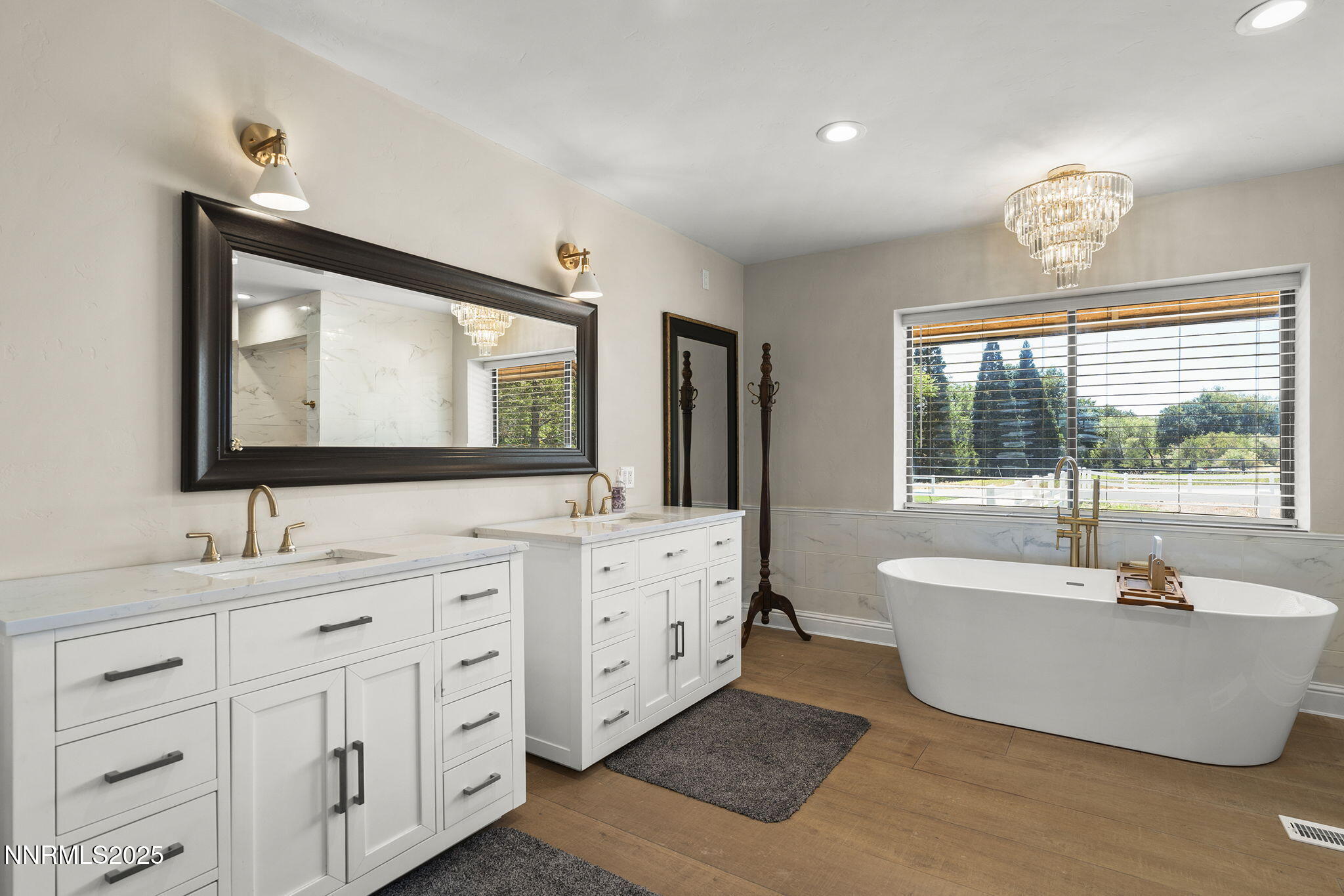 3485 Frost Lane Reno, NV 89511 - Photo 27 of 44 a spacious bathroom with double vanity a window a bathtub and a sink