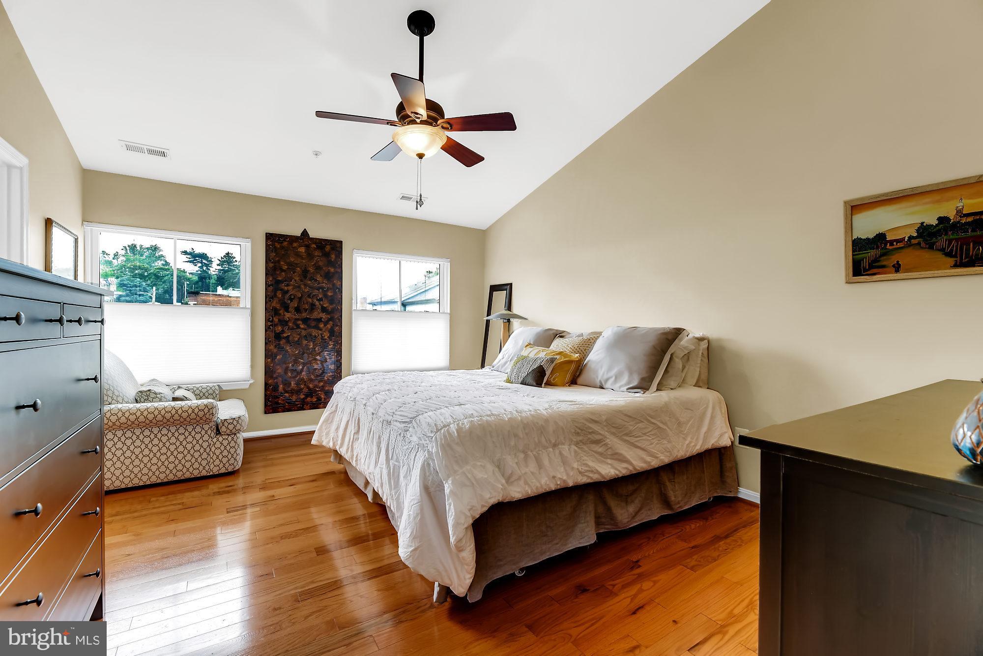 2090 Clipper Park Road Baltimore, MD 21211 - Photo 13 of 75 a bedroom with a bed and wooden floor