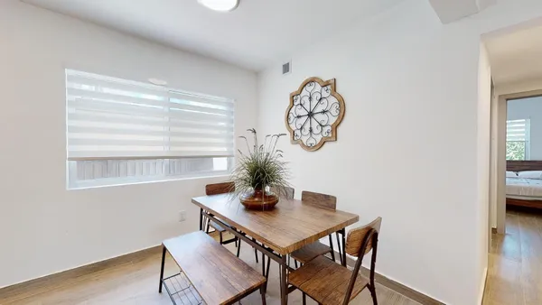 a view of a room with a table and chairs