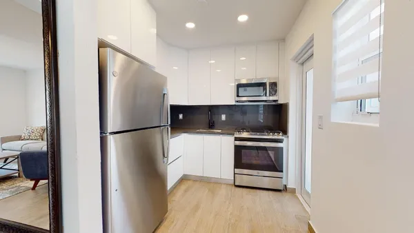 a kitchen with a refrigerator and a stove