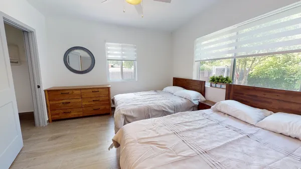a bedroom with bed and a large window
