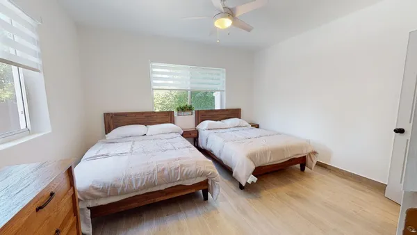 a bedroom with two beds and a window