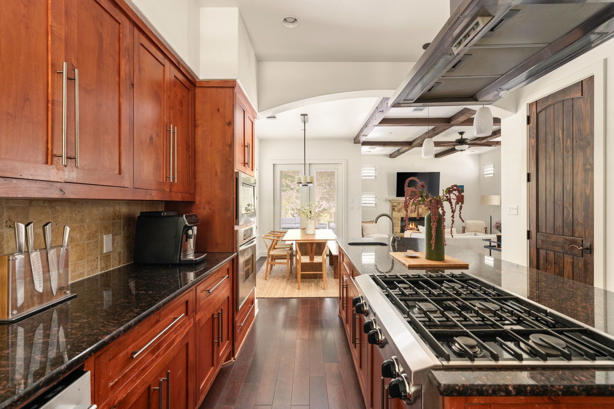 2324 Kinney Road Austin, TX 78704 - Photo 11 of 35 Rich wood cabinetry and polished stone countertops anchor this finely crafted culinary space.