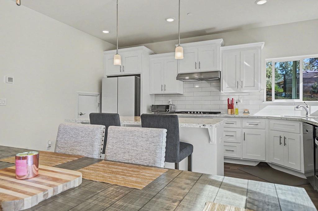 13871 Petersen Ranch Drive Pine Grove, CA 95665 - Photo 13 of 74 a kitchen with stainless steel appliances granite countertop a stove a sink and a refrigerator