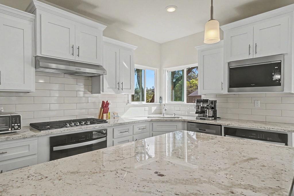 13871 Petersen Ranch Drive Pine Grove, CA 95665 - Photo 17 of 74 a kitchen with stainless steel appliances a stove sink microwave and cabinets