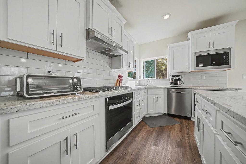 13871 Petersen Ranch Drive Pine Grove, CA 95665 - Photo 23 of 74 a kitchen with granite countertop cabinets stainless steel appliances a sink and window