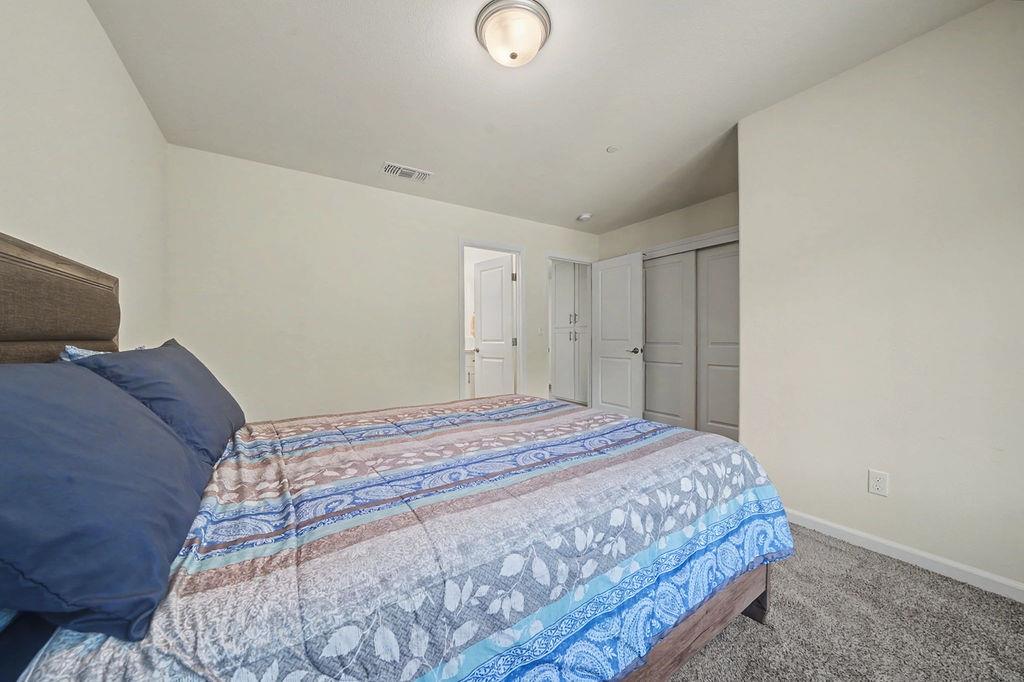 13871 Petersen Ranch Drive Pine Grove, CA 95665 - Photo 29 of 74 a bedroom with a bed and a lamp