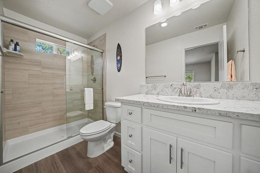 13871 Petersen Ranch Drive Pine Grove, CA 95665 - Photo 30 of 74 a bathroom with a granite countertop sink toilet a mirror and shower