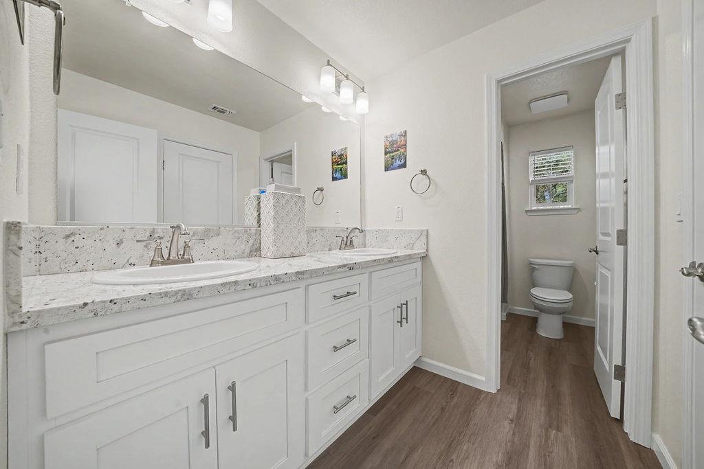 13871 Petersen Ranch Drive Pine Grove, CA 95665 - Photo 34 of 74 a spacious bathroom with a granite countertop sink a toilet and a large mirror