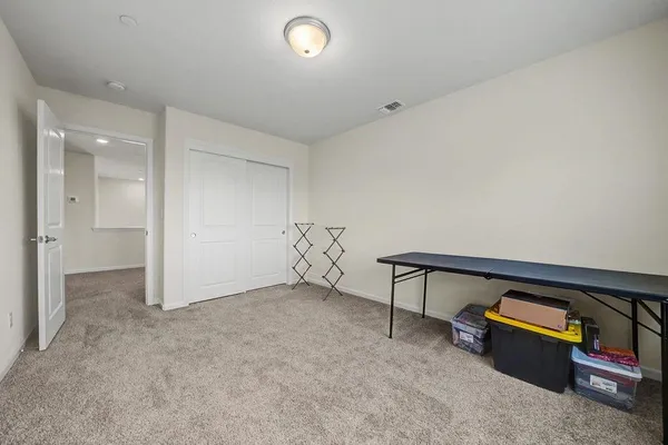 a view of a patio with table and chairs and potted plants