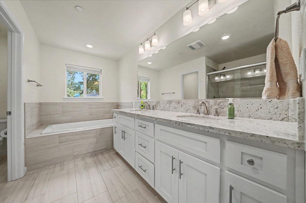 13871 Petersen Ranch Drive Pine Grove, CA 95665 - Photo 41 of 74 a bathroom with a granite countertop sink mirror and bathtub