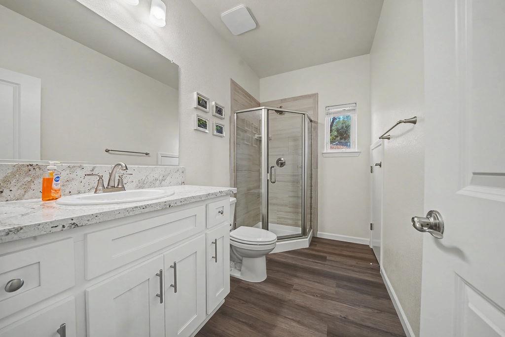 13871 Petersen Ranch Drive Pine Grove, CA 95665 - Photo 5 of 74 a bathroom with a sink a toilet a mirror and shower