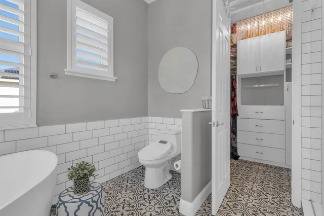 a bathroom with a toilet and a shower