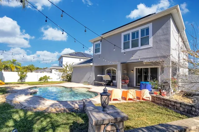 a view of a house with backyard outdoor seating area