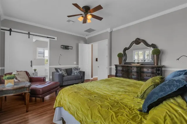 a bedroom with a bed and a chandelier