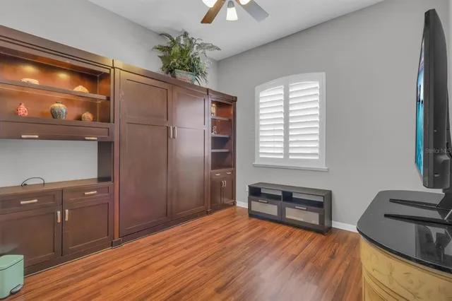 a room with wooden floor and furniture