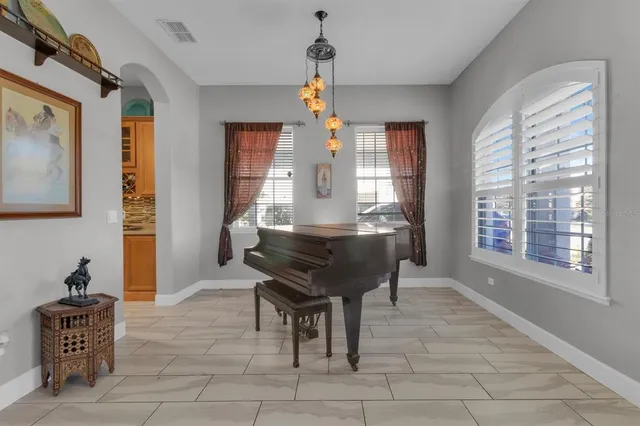 a living room with furniture a window and a chandelier
