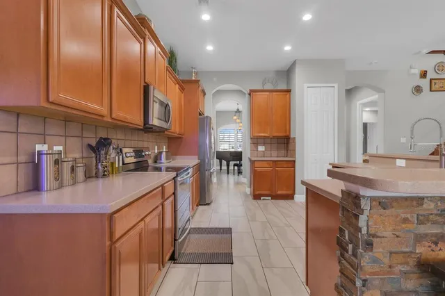 a kitchen with stainless steel appliances granite countertop a sink and cabinets