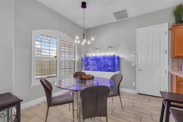 a dining room with furniture and window