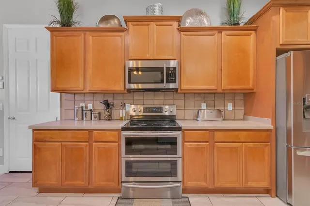 a kitchen with stainless steel appliances a stove and a refrigerator