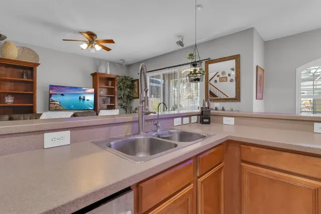 a kitchen with stainless steel appliances a sink and a refrigerator