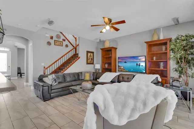 a living room with patio furniture and a chandelier