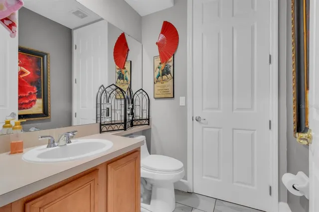 a bathroom with a sink vanity and mirror