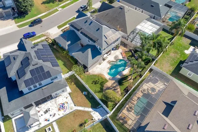 an aerial view of a house with a yard