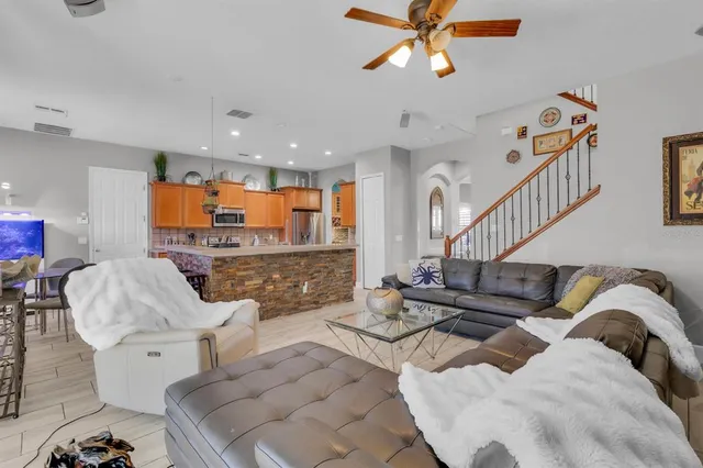a living room with furniture ceiling fan and a rug