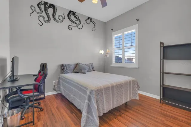 a bedroom with a bed and a chair in it