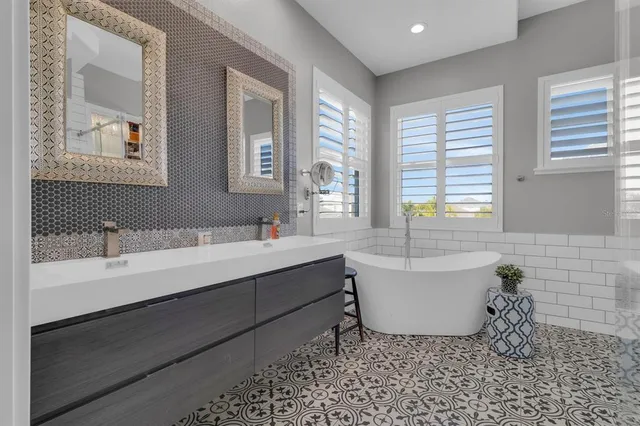 a bathroom with a bathtub sink and mirror