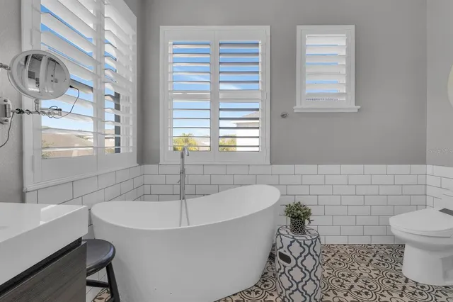 a white bath tub sitting next to a white toilet