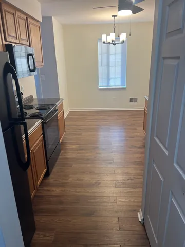 a kitchen with a refrigerator stove and cabinets