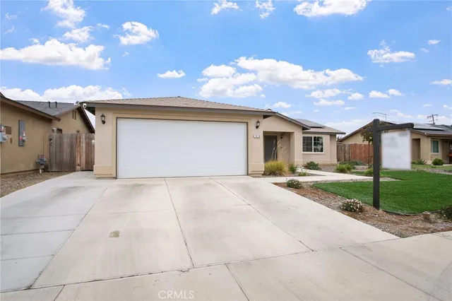 a view of a house with a yard and garage