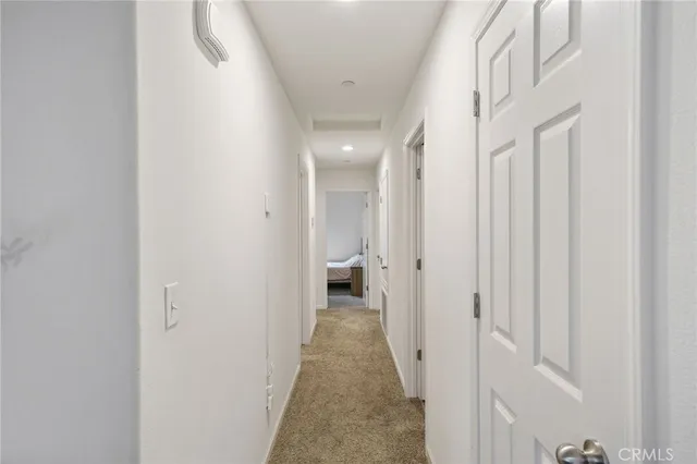 a view of a hallway with white walls