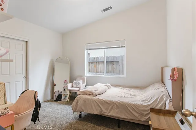 a bedroom with a bed and a chair